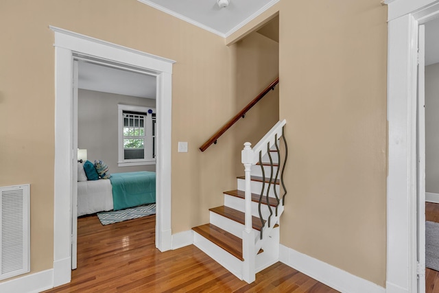 2642 Stuart St, Burns, TN 37029 - stairs with wood finished floors, baseboards, and crown molding
