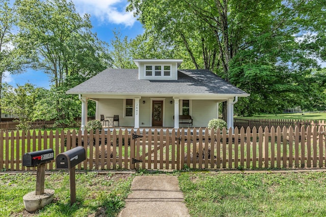 2642 Stuart St, Burns, TN 37029 - view of front of home featuring covered porch, a fenced front yard, roof with shingles, and a gate