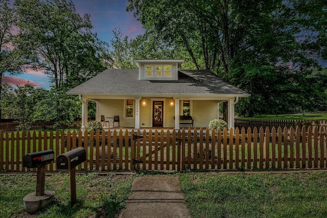 2642 Stuart St, Burns, TN 37029 - view of front facade featuring covered porch, a fenced front yard, and a shingled roof