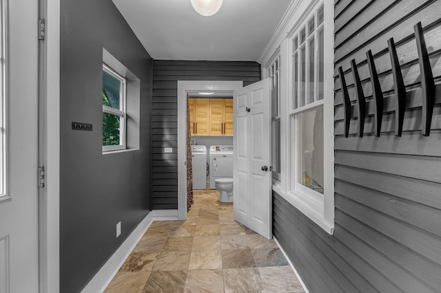 2642 Stuart St, Burns, TN 37029 - corridor with washing machine and clothes dryer, baseboards, and stone finish floors