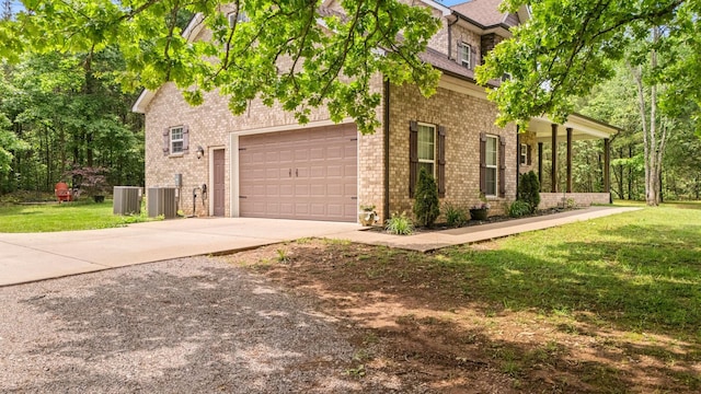 2101 Murray Kittrell Rd, Readyville, TN 37149 - view of front facade with driveway, a front lawn, central air condition unit, brick siding, and a garage