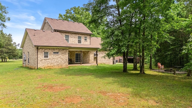 2101 Murray Kittrell Rd, Readyville, TN 37149 - rear view of property with brick siding, a yard, roof with shingles, and a patio