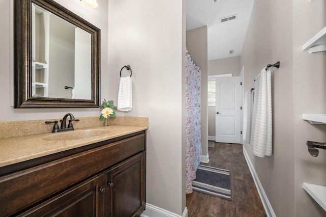 2101 Murray Kittrell Rd, Readyville, TN 37149 - full bath featuring wood finished floors, vanity, baseboards, and curtained shower