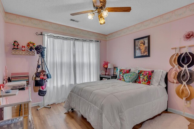 1383 Carters Creek Pike, Columbia, TN 38401 - bedroom featuring wood finished floors, a textured ceiling, a ceiling fan, and baseboards