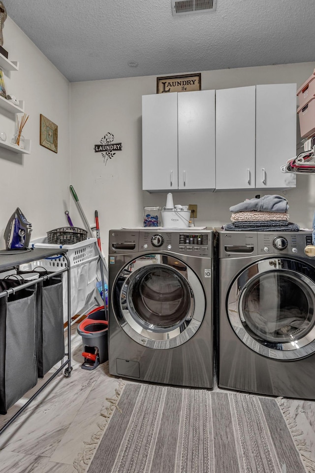 1383 Carters Creek Pike, Columbia, TN 38401 - clothes washing area with cabinet space, washer and clothes dryer, and a textured ceiling