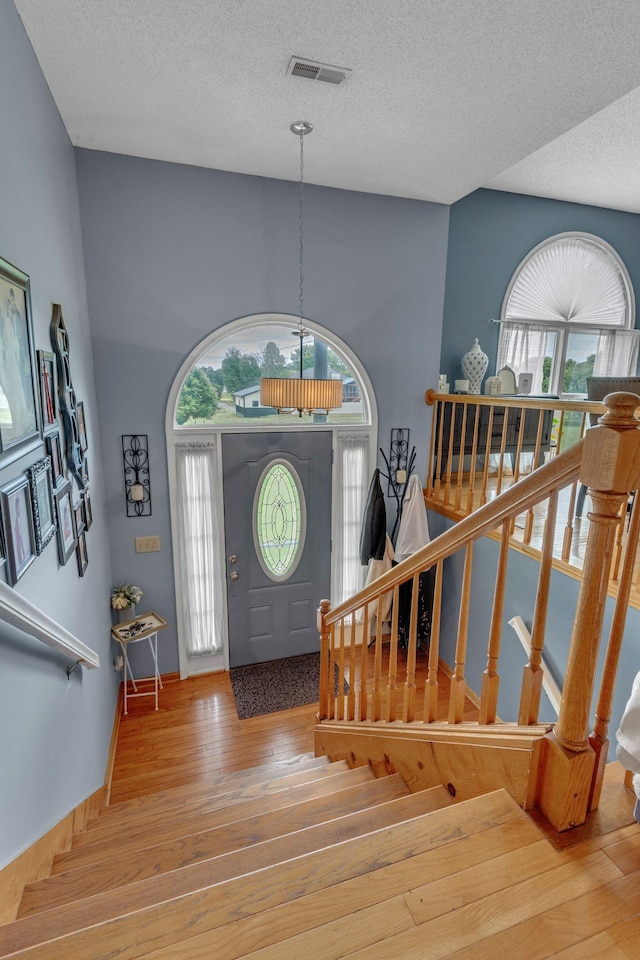 1383 Carters Creek Pike, Columbia, TN 38401 - entrance foyer featuring wood-type flooring, healthy amount of natural light, a textured ceiling, and stairway