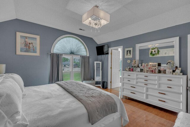 1383 Carters Creek Pike, Columbia, TN 38401 - bedroom with lofted ceiling, a chandelier, light wood finished floors, and a textured ceiling