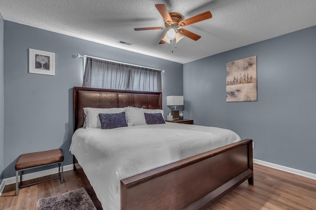 1383 Carters Creek Pike, Columbia, TN 38401 - bedroom featuring baseboards, wood finished floors, a ceiling fan, and a textured ceiling