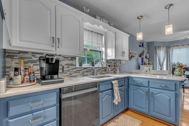 1383 Carters Creek Pike, Columbia, TN 38401 - kitchen featuring dishwasher, blue cabinets, a sink, a peninsula, and white cabinets