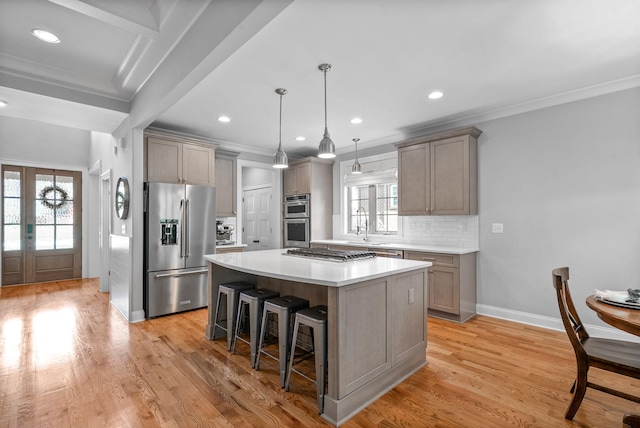 2477 Settlers Trce, Clarksville, TN 37043 - kitchen featuring stainless steel appliances, a kitchen island, a breakfast bar, crown molding, and decorative backsplash
