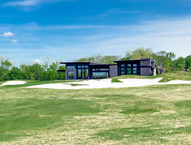 view of home's community featuring a yard and golf course view
