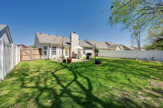 rear view of property with a patio and a chimney