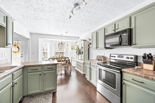 kitchen with electric range, black microwave, green cabinetry, dark wood-style floors, and a chandelier