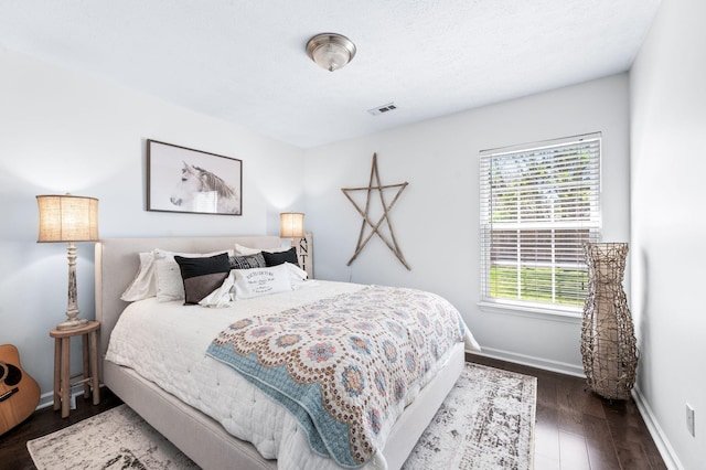 bedroom with wood finished floors and baseboards