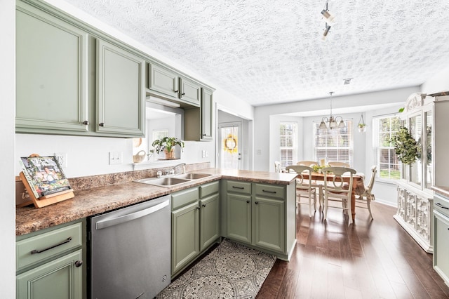 kitchen featuring dishwasher, green cabinetry, a sink, dark wood-style floors, and plenty of natural light