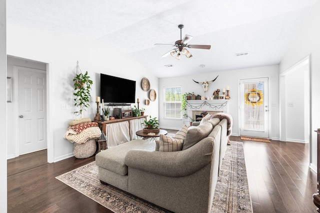 living area with a ceiling fan, lofted ceiling, dark wood-style floors, and baseboards