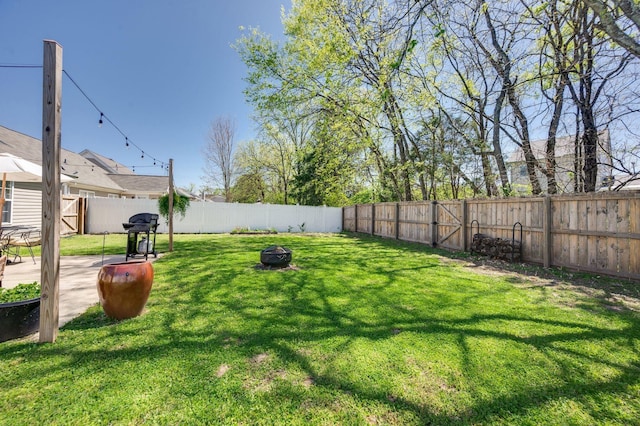 view of yard with a fire pit and a patio area