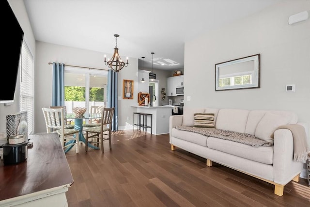 11 Sycamore Rdg W, Burns, TN 37029 - living area with dark wood-type flooring, a chandelier, and baseboards