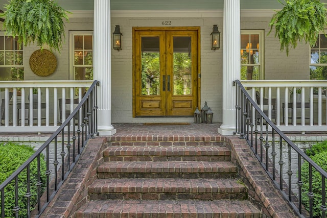 622 Stonewater Blvd, Franklin, TN 37064 - doorway to property with french doors, covered porch, and brick siding
