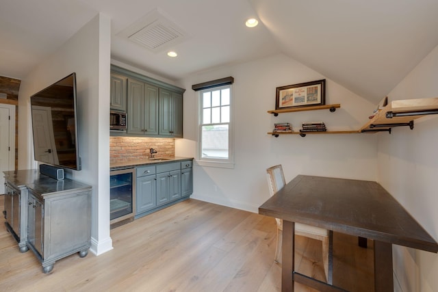 622 Stonewater Blvd, Franklin, TN 37064 - bar with wine cooler, light wood finished floors, stainless steel microwave, backsplash, and recessed lighting