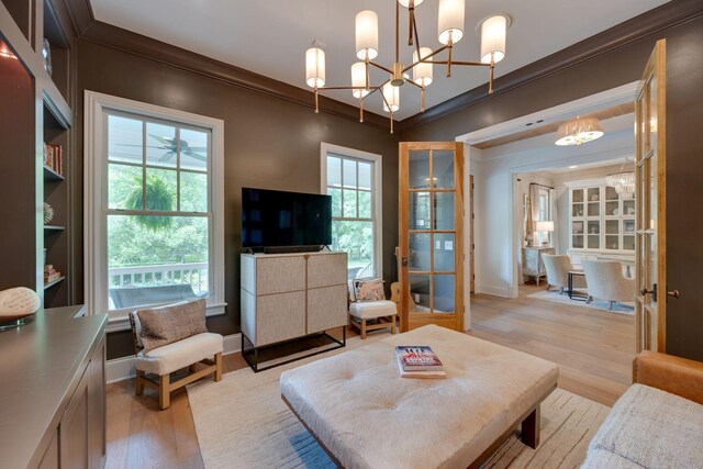 622 Stonewater Blvd, Franklin, TN 37064 - living room with crown molding, light wood-style floors, a chandelier, and baseboards