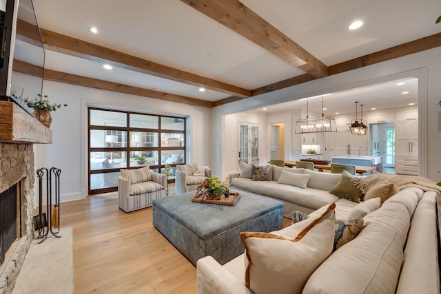 622 Stonewater Blvd, Franklin, TN 37064 - living room featuring beamed ceiling, a fireplace, a chandelier, light wood-type flooring, and recessed lighting