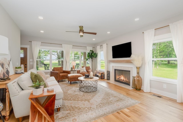 4345 S Garrett Rd, Springfield, TN 37172 - living room with a fireplace with flush hearth, a ceiling fan, wood finished floors, recessed lighting, and baseboards
