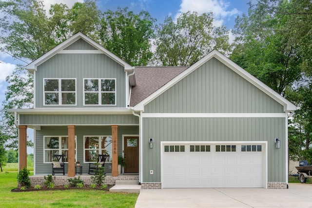 4345 S Garrett Rd, Springfield, TN 37172 - view of front of property featuring a porch, a garage, driveway, roof with shingles, and board and batten siding