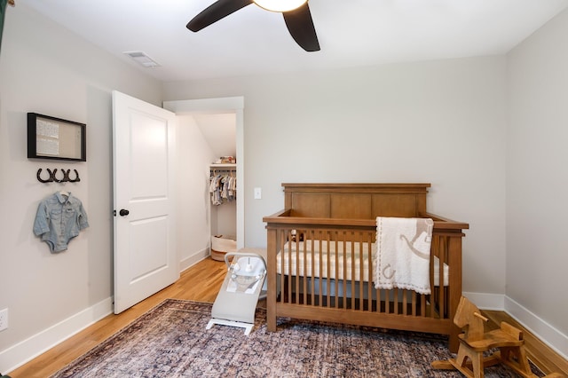 4345 S Garrett Rd, Springfield, TN 37172 - bedroom featuring wood finished floors, baseboards, a crib, and ceiling fan