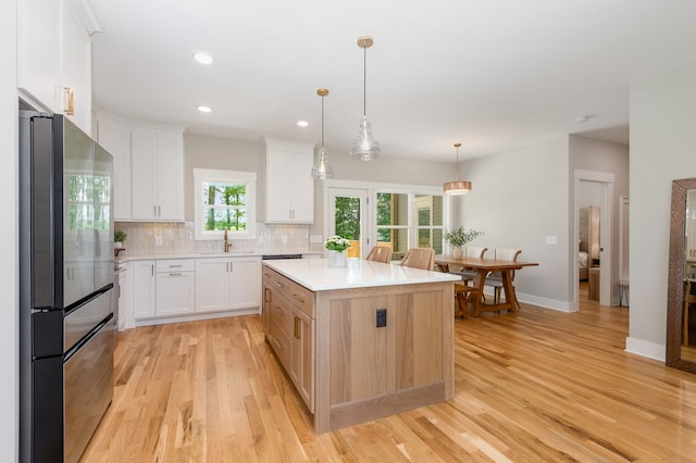4345 S Garrett Rd, Springfield, TN 37172 - kitchen featuring freestanding refrigerator, a sink, light wood-style flooring, light countertops, and white cabinets