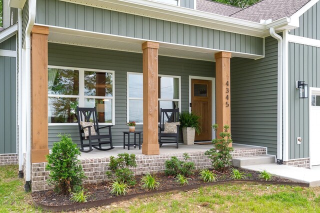 4345 S Garrett Rd, Springfield, TN 37172 - property entrance with covered porch, a shingled roof, and board and batten siding