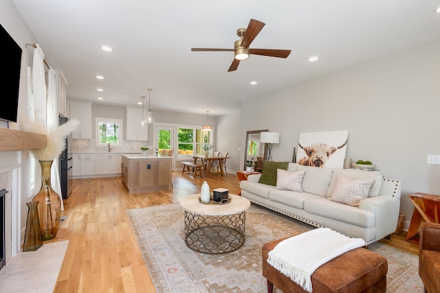 4345 S Garrett Rd, Springfield, TN 37172 - living room featuring light wood-type flooring, ceiling fan, recessed lighting, and a fireplace