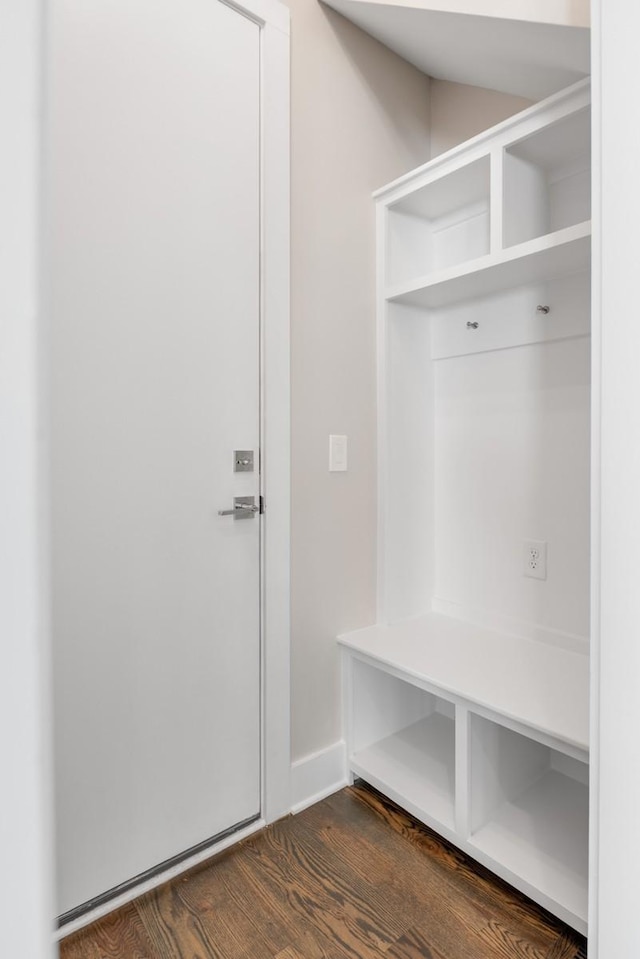 mudroom with dark wood-type flooring and baseboards