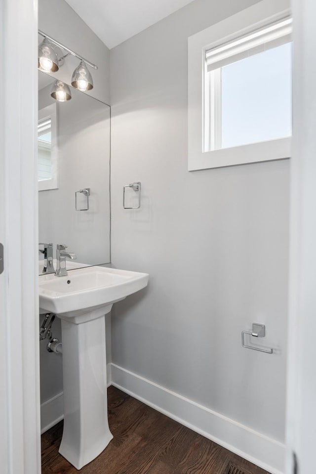bathroom with baseboards and wood finished floors