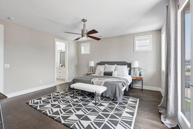 bedroom with wood finished floors, baseboards, ceiling fan, and ensuite bathroom