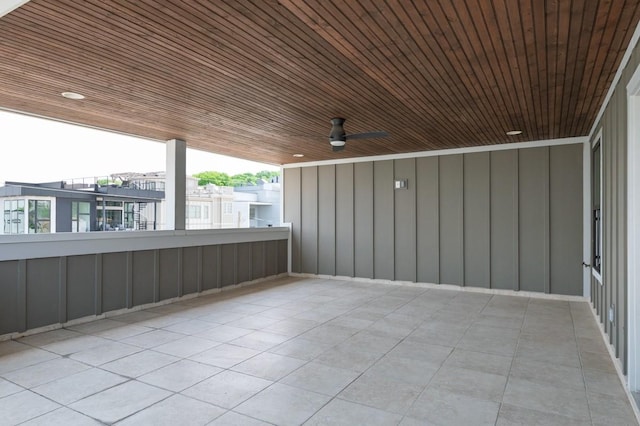 view of patio with ceiling fan and a balcony