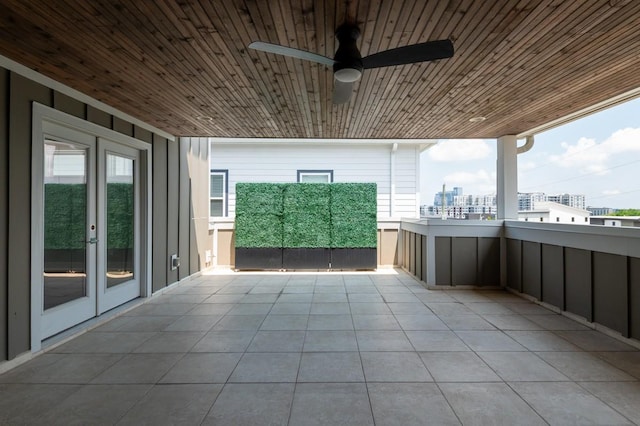 view of patio featuring french doors, a balcony, ceiling fan, and a view of city