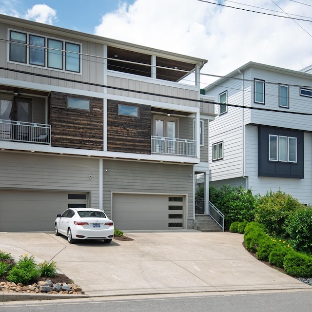 view of front of property featuring a balcony, an attached garage, and concrete driveway