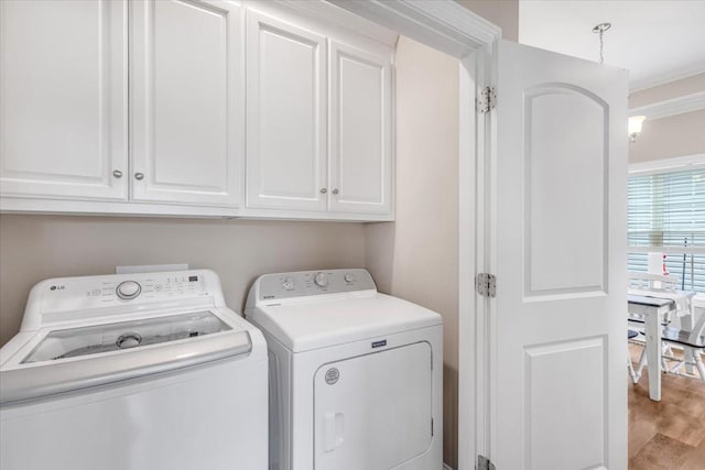401 Hancock Ln, Tullahoma, TN 37388 - washroom with cabinet space, independent washer and dryer, and wood finished floors