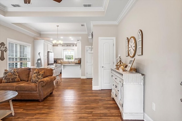 401 Hancock Ln, Tullahoma, TN 37388 - living room featuring dark wood finished floors, a chandelier, crown molding, baseboards, and a raised ceiling