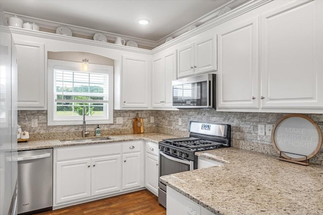 401 Hancock Ln, Tullahoma, TN 37388 - kitchen featuring stainless steel appliances, a sink, white cabinetry, and decorative backsplash