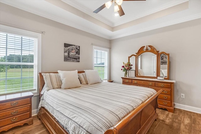 401 Hancock Ln, Tullahoma, TN 37388 - bedroom with baseboards, dark wood-style floors, crown molding, ceiling fan, and a raised ceiling
