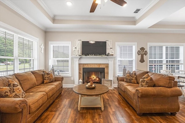 401 Hancock Ln, Tullahoma, TN 37388 - living room featuring a raised ceiling, dark wood-style flooring, a ceiling fan, a tile fireplace, and ornamental molding