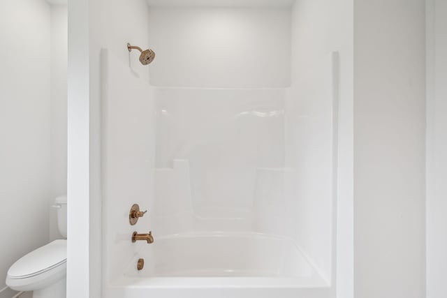 bathroom featuring toilet and washtub / shower combination