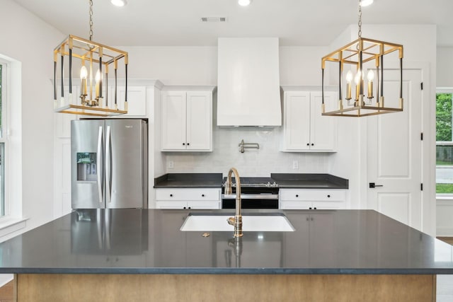 kitchen featuring appliances with stainless steel finishes, a chandelier, dark countertops, backsplash, and recessed lighting