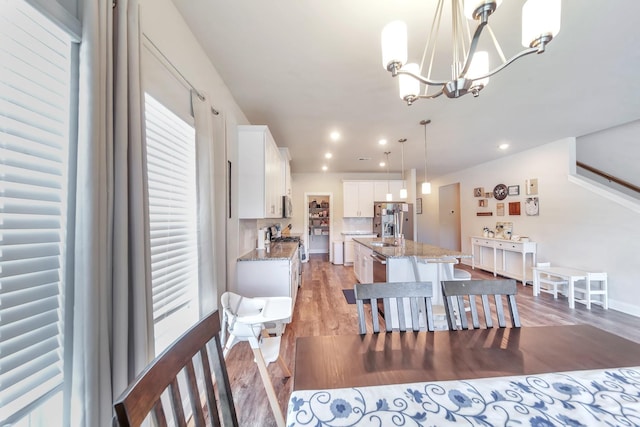 4022 Arrowleaf Ln, Antioch, TN 37013 - dining area with light wood-style floors, plenty of natural light, a chandelier, recessed lighting, and baseboards