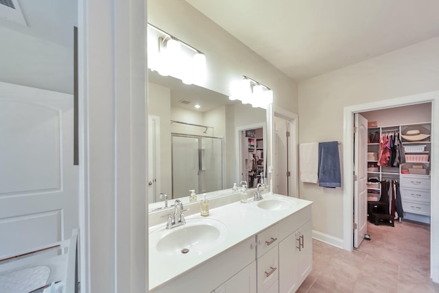 4022 Arrowleaf Ln, Antioch, TN 37013 - full bathroom with a stall shower, double vanity, a spacious closet, and tile patterned flooring
