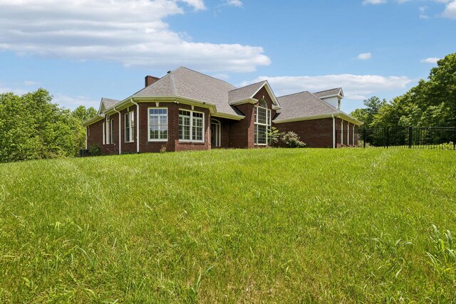 219 Dale Ln, Hilham, TN 38568 - back of property featuring fence, brick siding, and a chimney