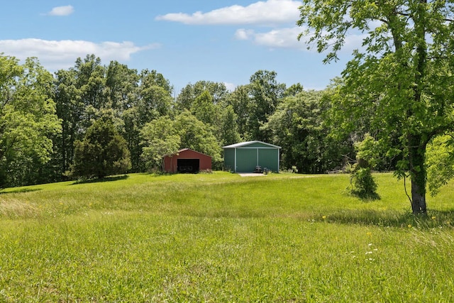 219 Dale Ln, Hilham, TN 38568 - view of yard with a detached garage, an outdoor structure, a pole building, and a forest view