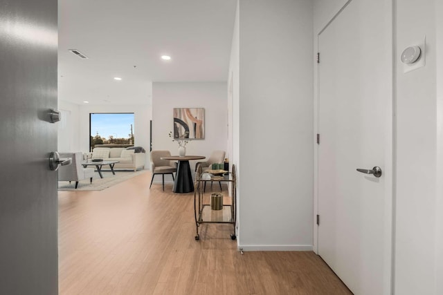 corridor featuring light wood-style floors and recessed lighting